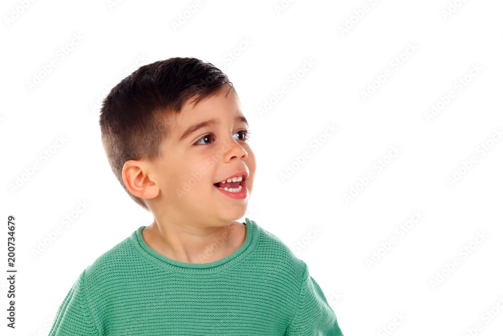 Pensive child with green t-shirt looking up Pensive child with green t-shirt looking up