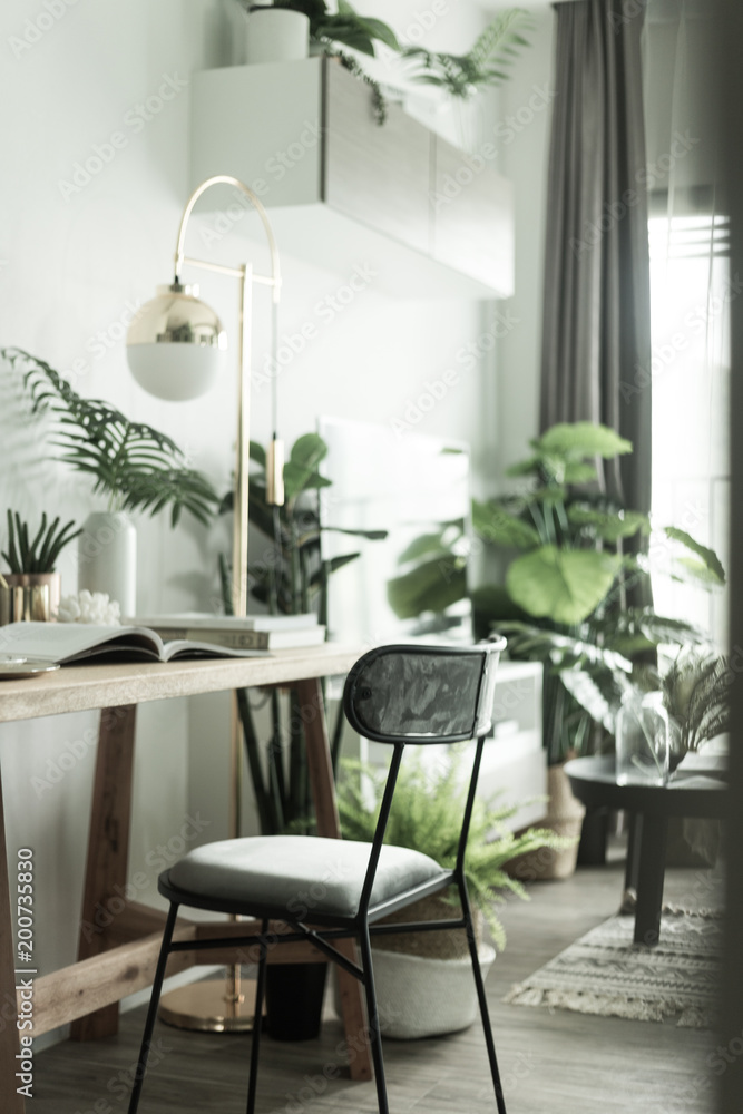 Working corner in apartment with Scandinavian style decoration and artificial plants in background / Cozy Interior Concept / Work from home