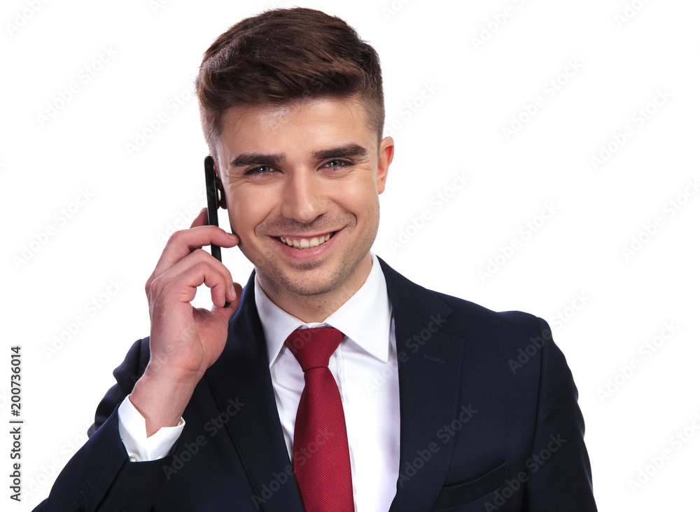 handsome laughing businessman is talking on the phone handsome laughing businessman is talking on the phone