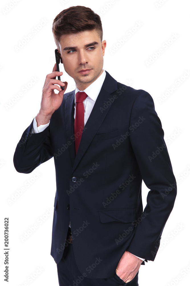 relaxed businessman speaking on the phone looks to side relaxed businessman speaking on the phone looks to side