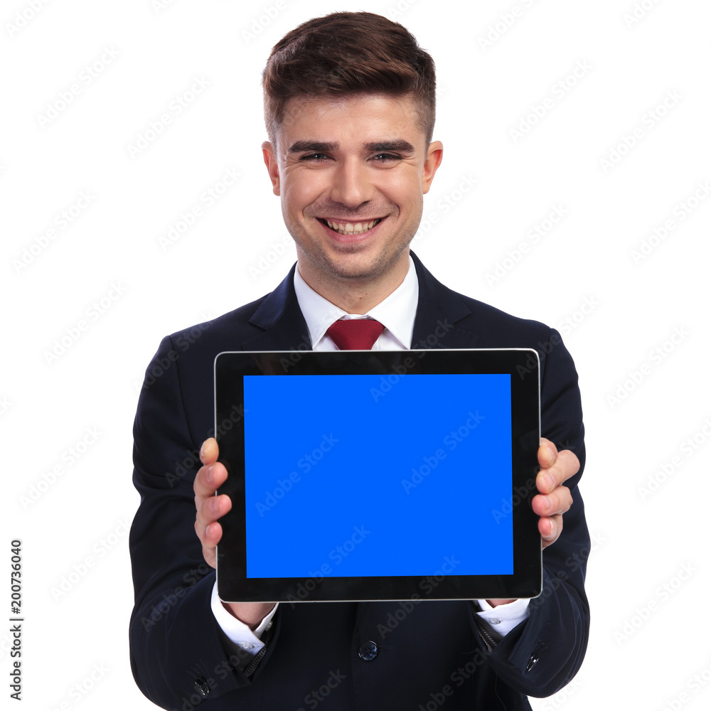 smiling businessman showing the blank blue screen of tablet smiling businessman showing the blank blue screen of tablet
