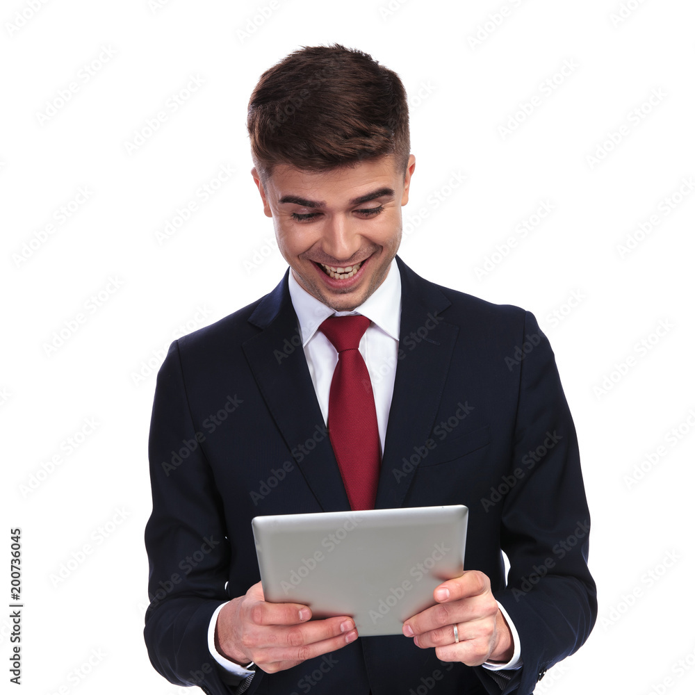 laughing businessman looking at something funny on tablet laughing businessman looking at something funny on tablet
