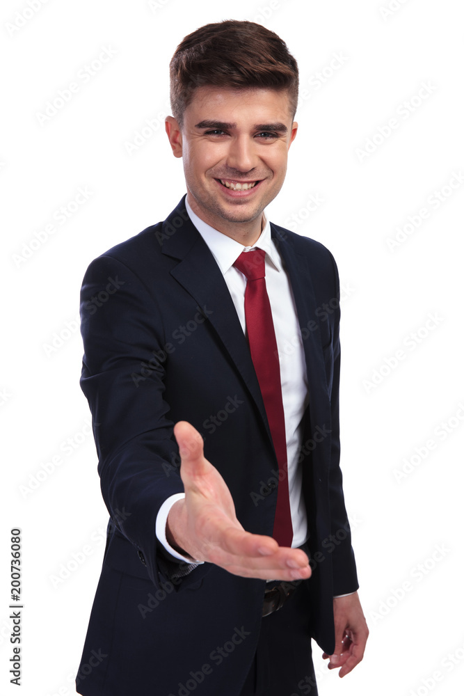 happy young businessman making a welcoming gesture happy young businessman making a welcoming gesture