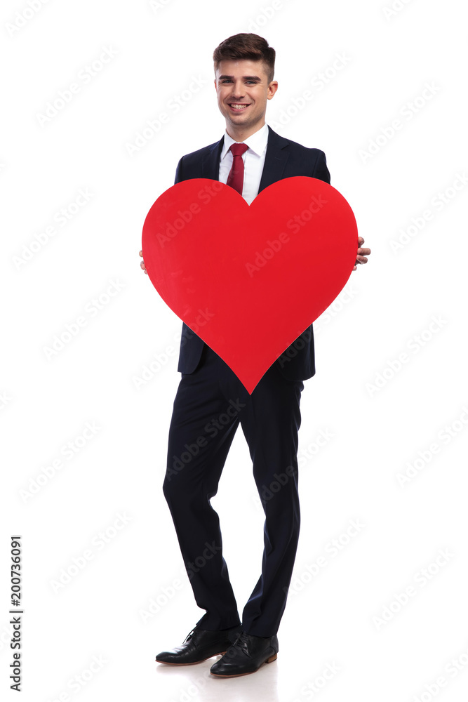 businessman in love holds a big red heart businessman in love holds a big red heart