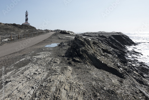 Lighthouse on the slate cape of Favaritx, Menorca, Balearic Islands, Spain