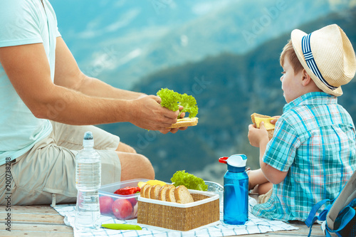 Family on a picnic in the mountains photo