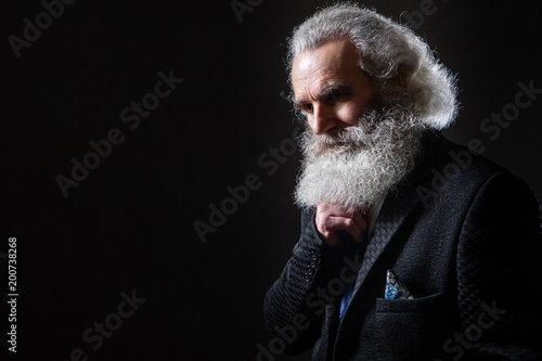 A man with a large gray bea...