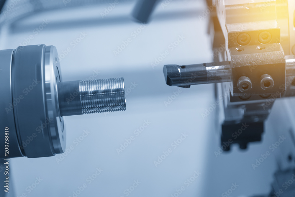 The CNC turning or lathe machine cutting the thread at the end of tube in the light blue scene. The CNC turning or lathe machine cutting the thread at the end of tube in the light blue scene.