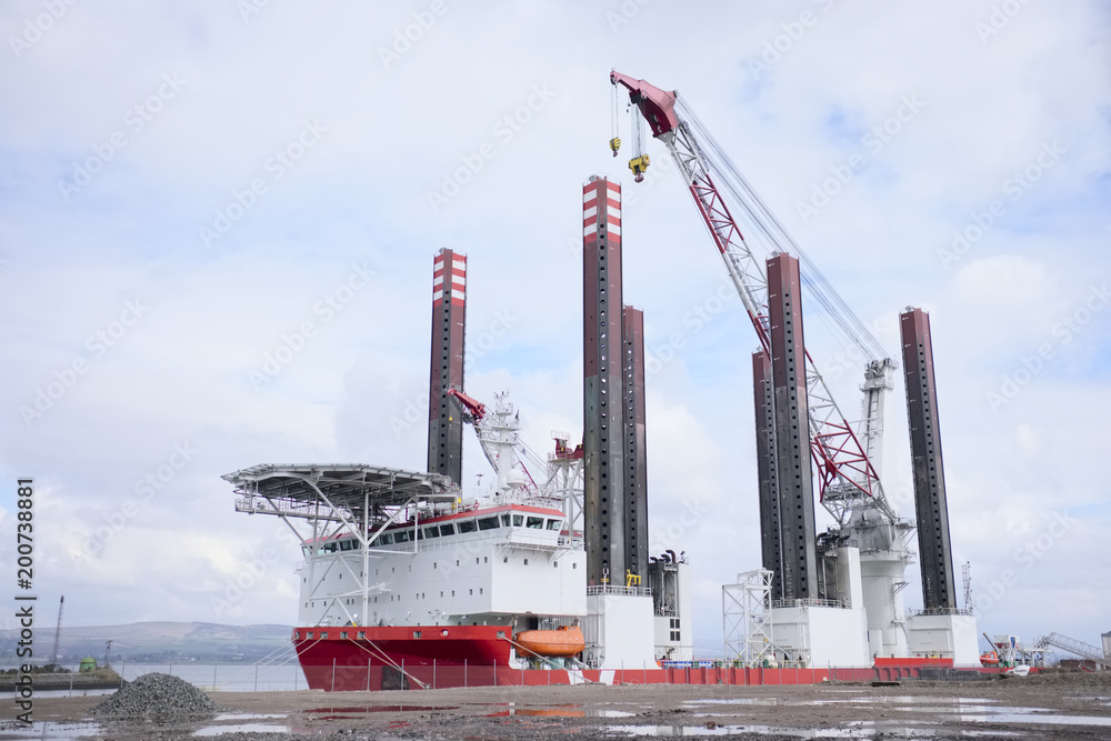 Obraz premium Shipbuilding tower crane in progress tall at dock port harbour harbor coastal steel vessel