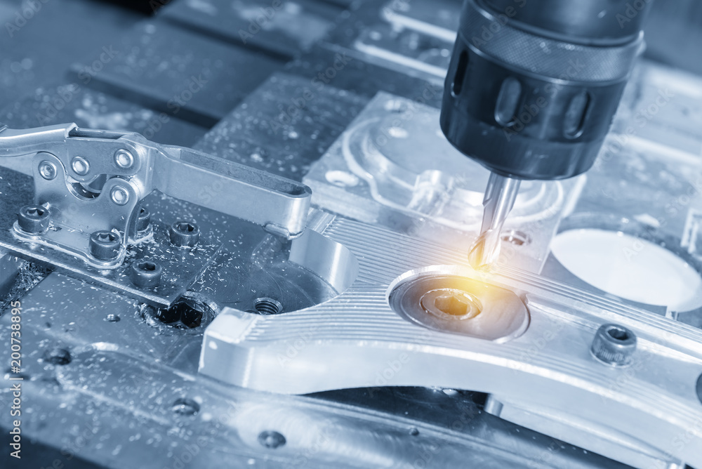The CNC milling machine cutting the aluminum automotive part with the solid ball endmill in the light blue scene. The CNC milling machine cutting the aluminum automotive part with the solid ball endmill in the light blue scene.