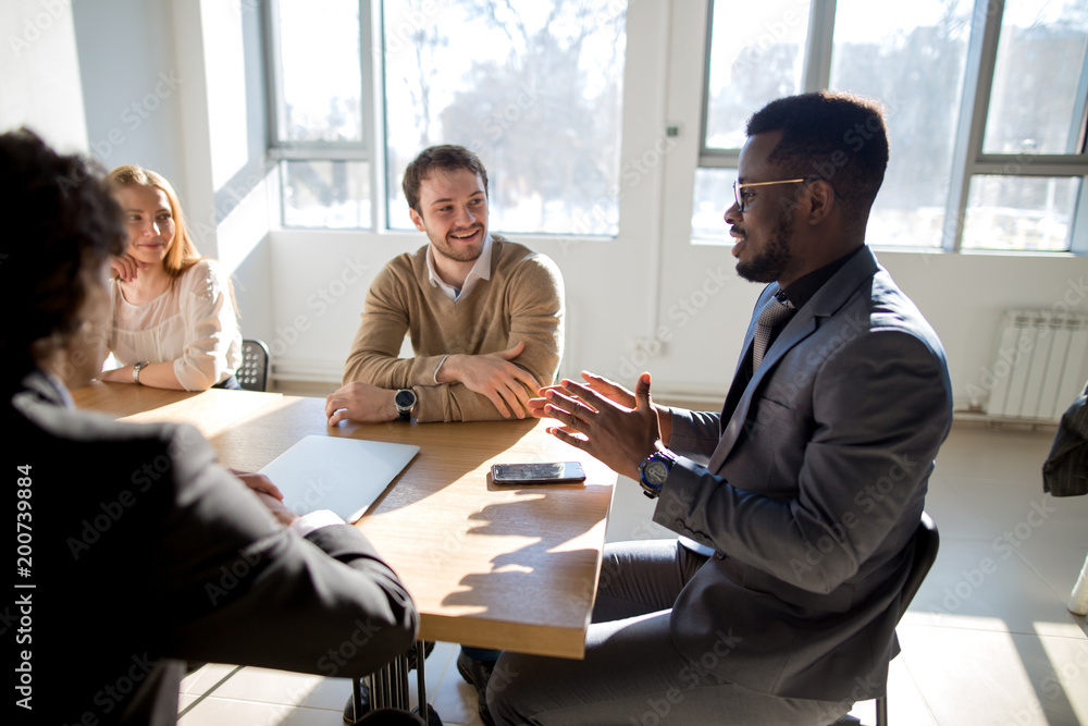 © alfa27 - black african head of company speaks about success of a new business © alfa27 - black african head of company speaks about success of a new business