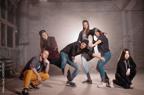 horizontal shot of unpredictable street youth in building. daring teens. photo