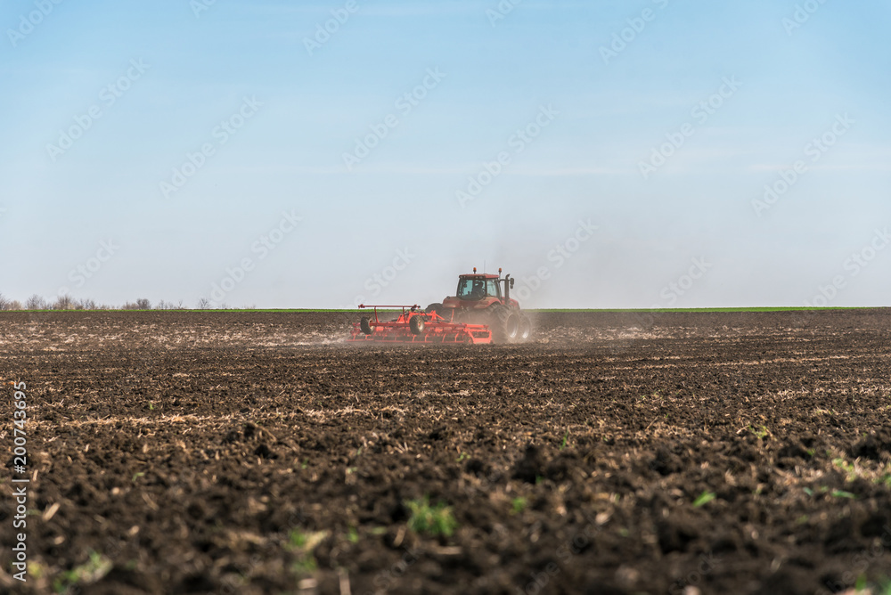 Fototapeta premium Tractor plowing fields.