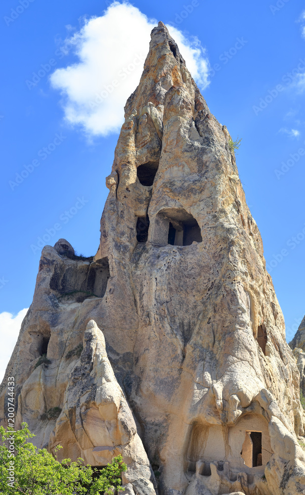 Cappadocia: Ancient  rock dwellings carved into natural volcanic rock formations in  the cappadocian landscape at Goreme