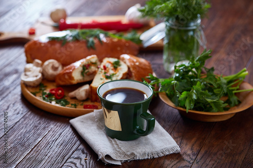 Country side still life with homemade pastries, coffee cup, herbs, vegetables over a vintage background, selective focus