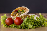 Tortilla, sauce, salad and tomato. Delicious and healthy meal. Mexican specialty. Mexican very popular specialty.