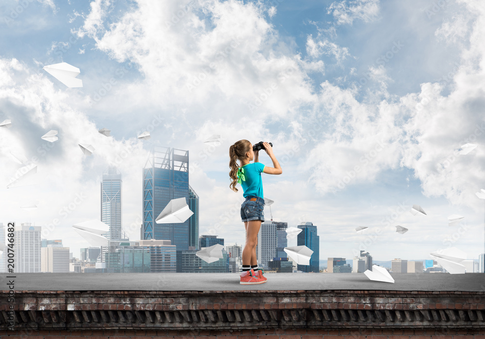 Concept of careless happy childhood with girl of school age looking in future Concept of careless happy childhood with girl of school age looking in future