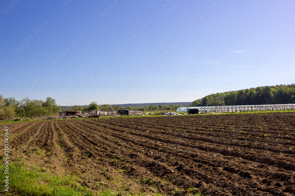 Agricultural field with greenhouses
