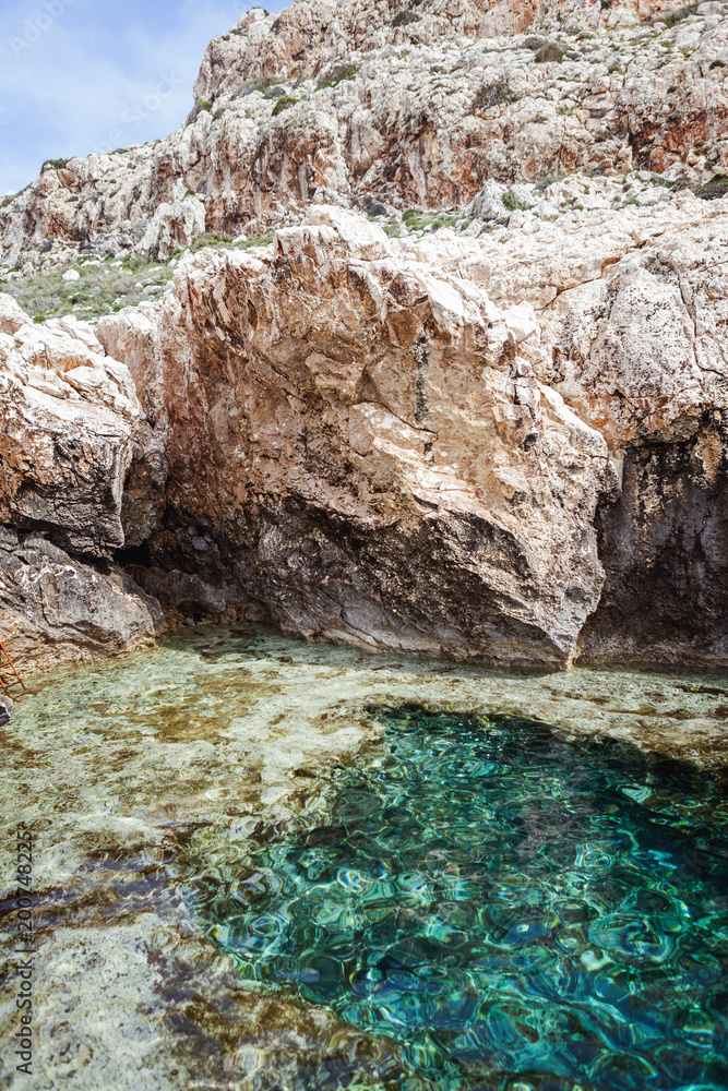 A bay with turquoise water in the rocks on the sea, Cape Greco, the island of Cyprus