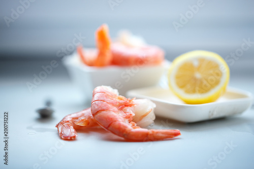 row tiger shrimp with lemon on white