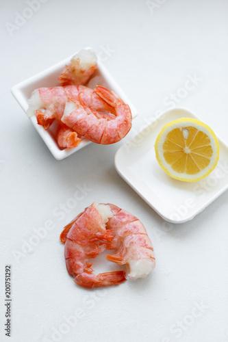 row tiger shrimp with lemon on white