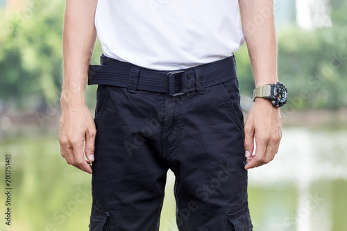 man wearing black cargo pants and standing in the nature park