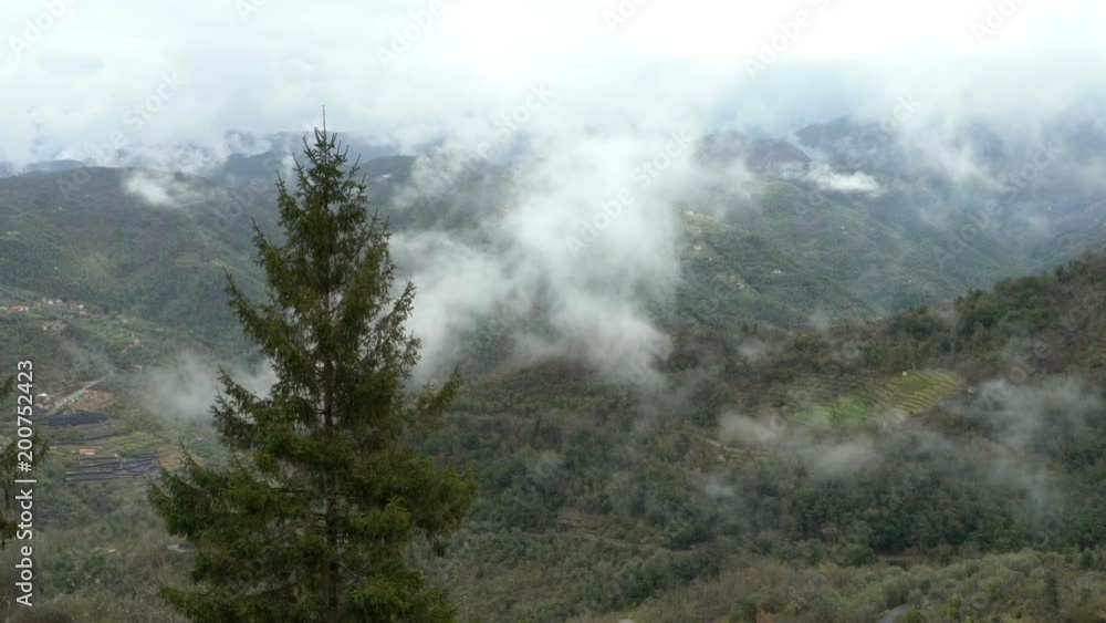 Early foggy morning in the Alps. Fog from the mountains falls into the valley. Perinaldo, Italy. Early foggy morning in the Alps. Fog from the mountains falls into the valley. Perinaldo, Italy.