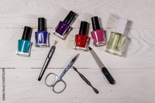 Basic set of manicure tools on white wooden background