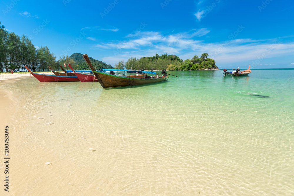 White sand beach and Long-tail boat at Kham-Tok Island (koh-kam-tok), The beautiful sea Ranong Province, Thailand. White sand beach and Long-tail boat at Kham-Tok Island (koh-kam-tok), The beautiful sea Ranong Province, Thailand.