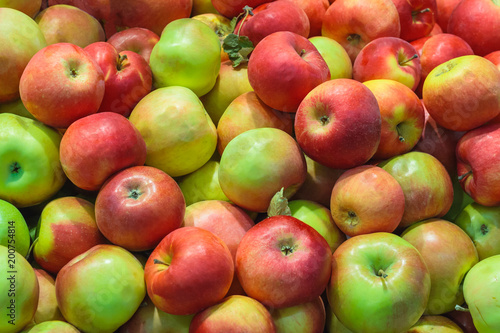 A pile of red-green apples as background, texture