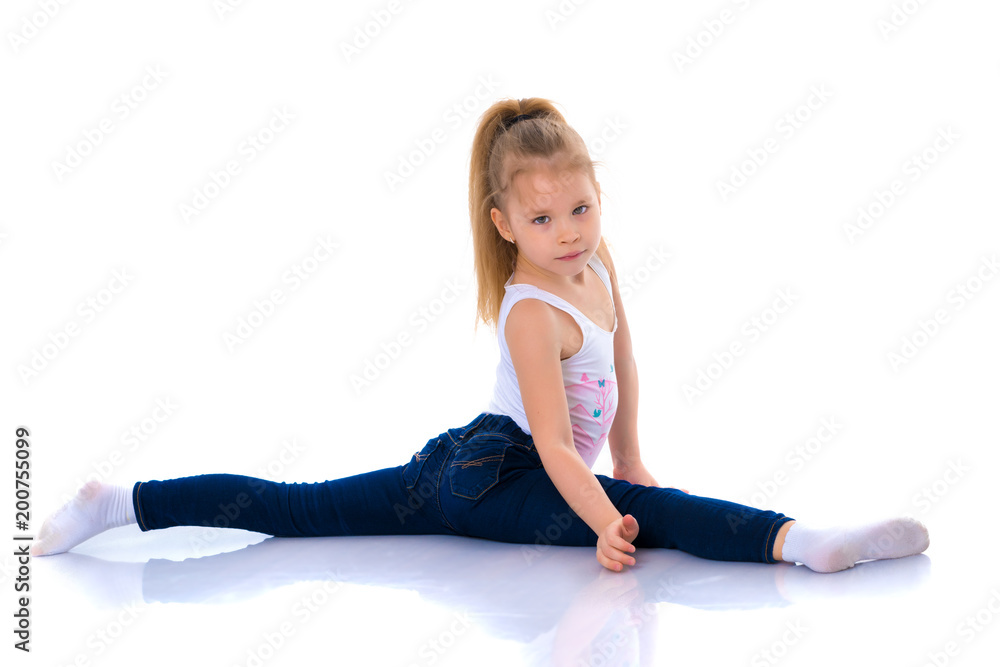 Girl gymnast perform the twine exercise. Girl gymnast perform the twine exercise.
