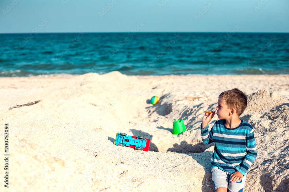 A boy is playing on the beach. A boy is playing on the beach.
