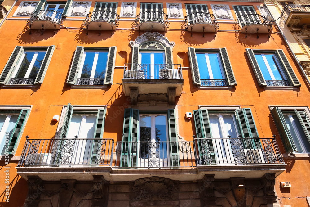 Facade of traditional colorful european italian apartment building in Rome , Italy.