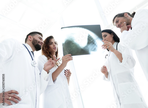 medical workers looking at patient's x-ray film