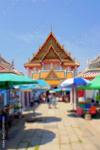 The entrance to the Thai temple, shops and tourists.