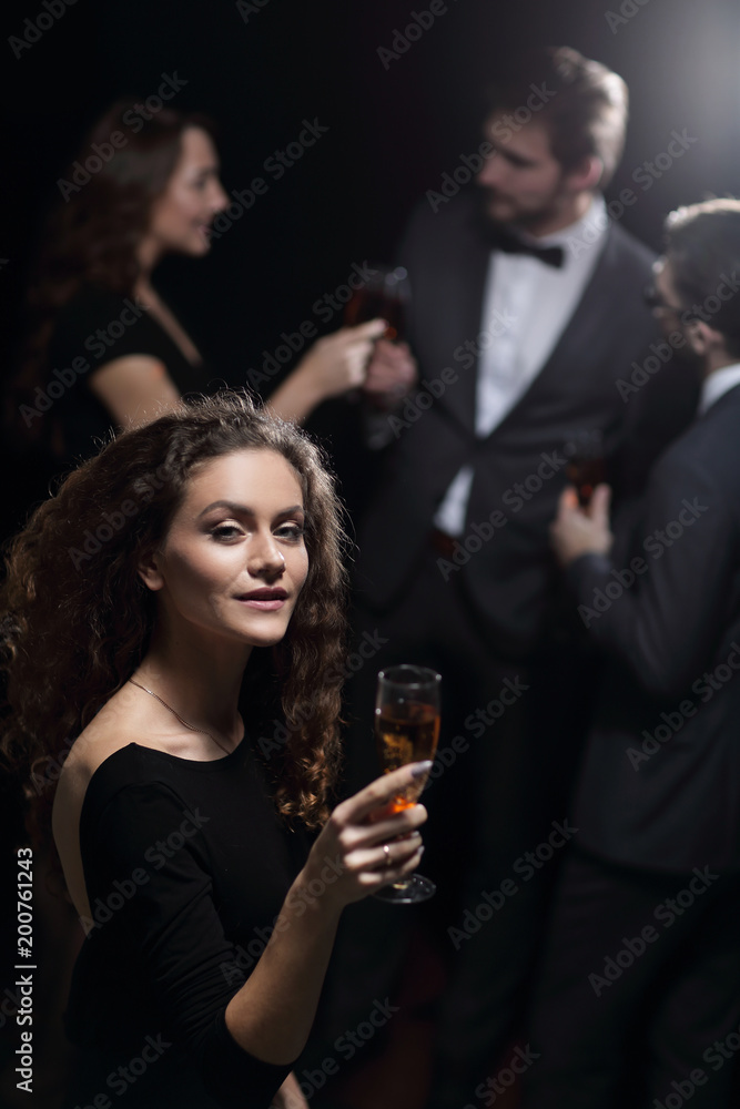 stylish young woman raising a glass of champagne