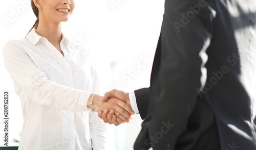 handshake young business woman with a colleague © ASDF