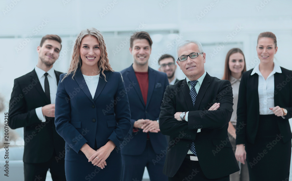 businessman and business woman standing in front of the business team. businessman and business woman standing in front of the business team.
