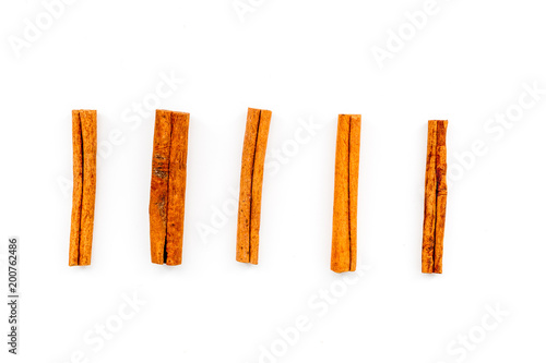 Cinnamon sticks on white background top view. Condiment for mulled wine