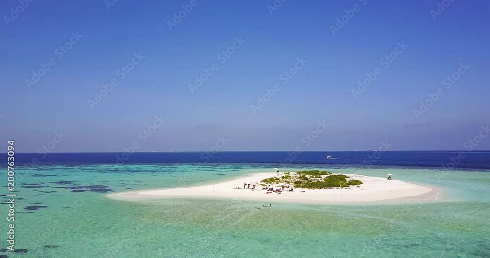 Aerial view of a desert island with a clear and transparent sea and a pristine beach. Concept of: holidays, maldives, dream landscapes. Aerial view of a desert island with a clear and transparent sea and a pristine beach. Concept of: holidays, maldives, dream landscapes.
