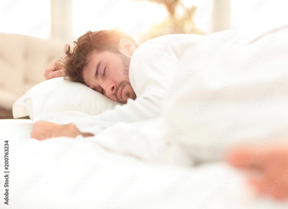 closeup.the tired men sleep soundly on the bed closeup.the tired men sleep soundly on the bed