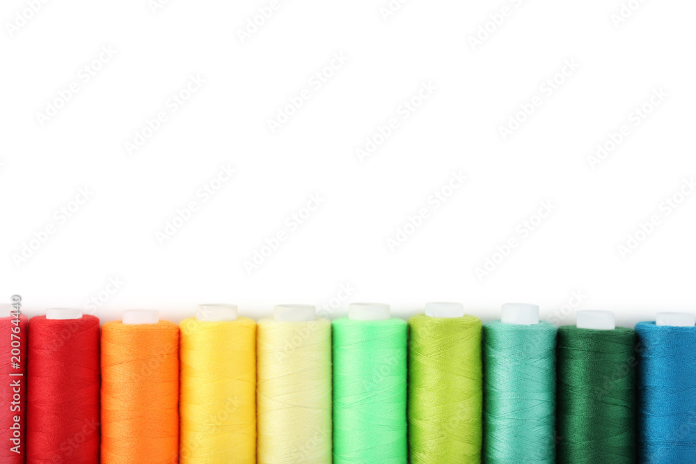 Colourful thread spools on white background Colourful thread spools on white background