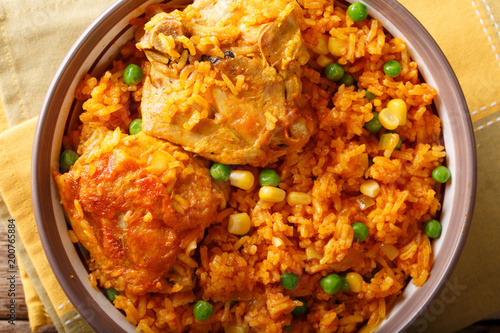 traditional spicy Brazilian food: chicken and rice close-up on a plate. horizontal top view