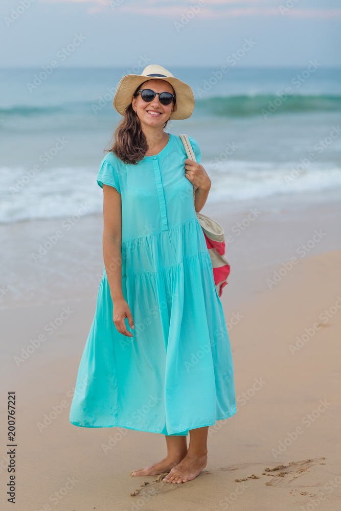 Woman at the seashore of Indian ocean on a cloudy day