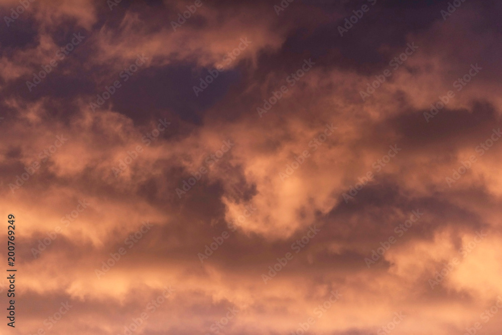 Close-up of brown orange coloured clouds during sunset. Close-up of brown orange coloured clouds during sunset.