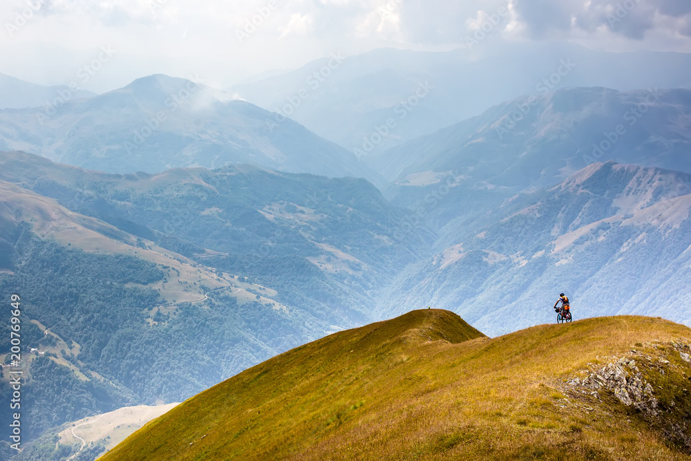Naklejka premium Mountain biker is travelling in the highlands of Tusheti region, Georgia
