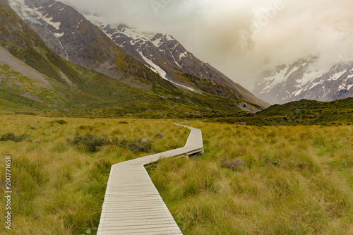 Wooden walking path leading to Hooker valley track, New Zealand natural landscape background
