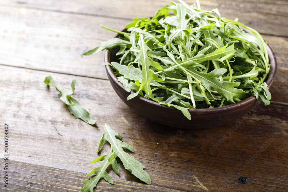 Fresh arugula leaves, rucola, fresh rucola in a plate, space for text. Fresh arugula leaves, rucola, fresh rucola in a plate, space for text.