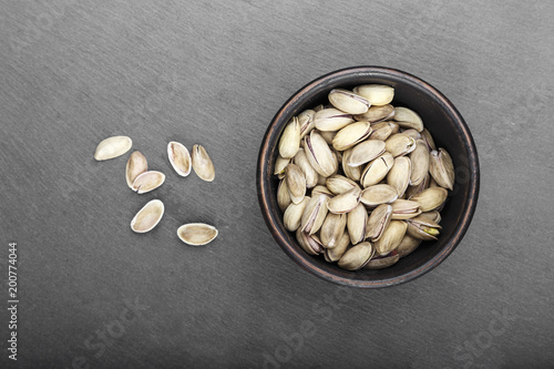 pistachios in a plate on a black background photo