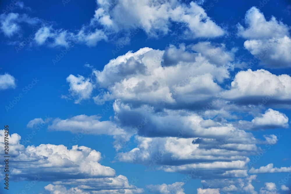 Fototapeta premium Summer day. Beautiful cumulus clouds in a blue sky. Background